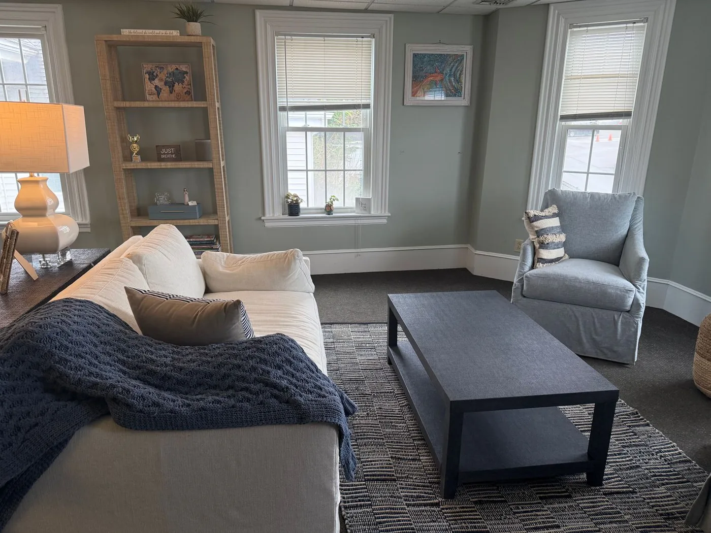 Private therapy session room at True North Counseling Plymouth MA with armchairs, chalkboard wall, and calming decor